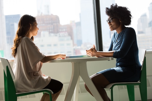 two employees talking at work